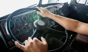 Truck Driver Holding a Steering Wheel