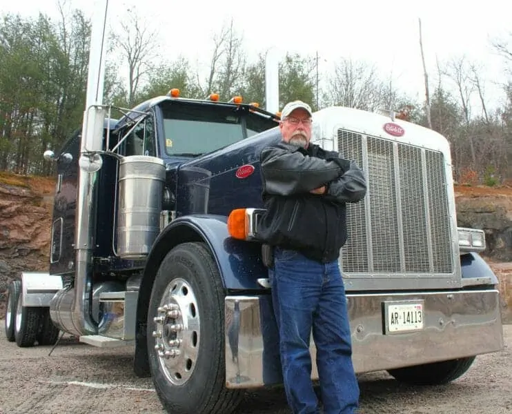 Experienced Veteran Truck Driver Smart Trucking Leaning on 379 Peterbilt 40 year Trucking Career