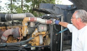 Trucker Fixing Caterpillar Diesel Engine