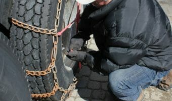 Tightening Tire Chains on Big Rig