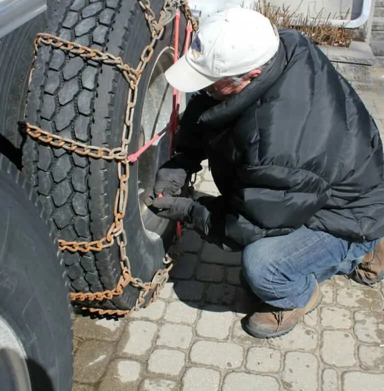 Tightening Tire Chains on Big Rig