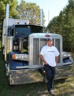 Owner Operator Standing by His Peterbilt Big Rig
