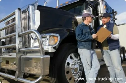 2 Truckers Talking by their Truck