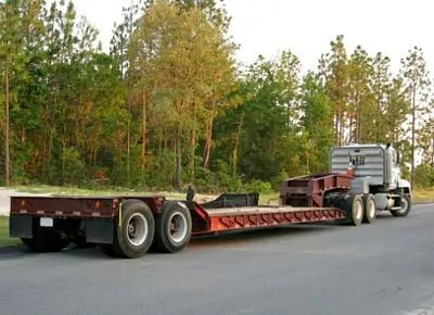 Flat Bed Trailer and Semi Truck Waiting to Load