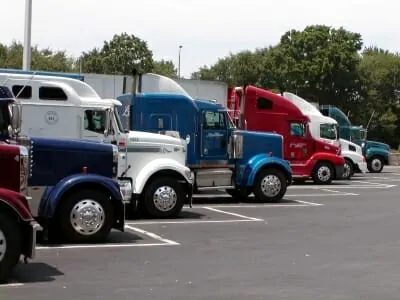 Multiple trucks lined up at truck stop