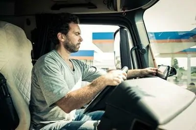 Truck Driver at the Wheel at Truck Stop