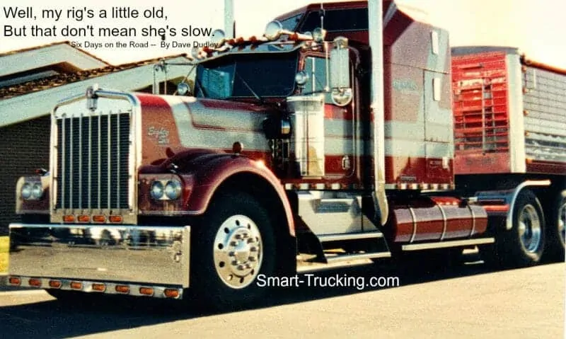 An old photo of an 1980 W900A Kenworth truck. It is red with silver stripes. There's a quote in a text overlay, saying: "Well, my rig's a little old, But that don't mean she's slow".
