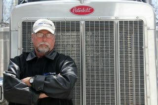 Trucker standing by Peterbilt Big Rig