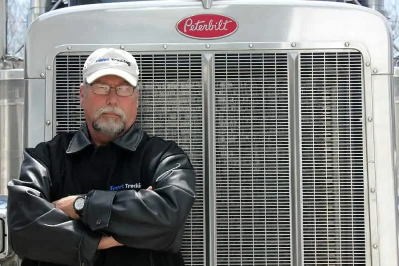 Owner Operator Trucker standing by Peterbilt Big Rig