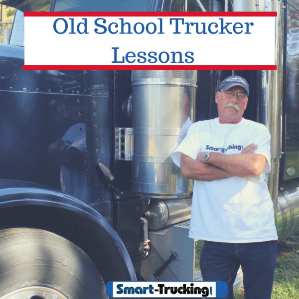 Old school trucker standing by blue big rig