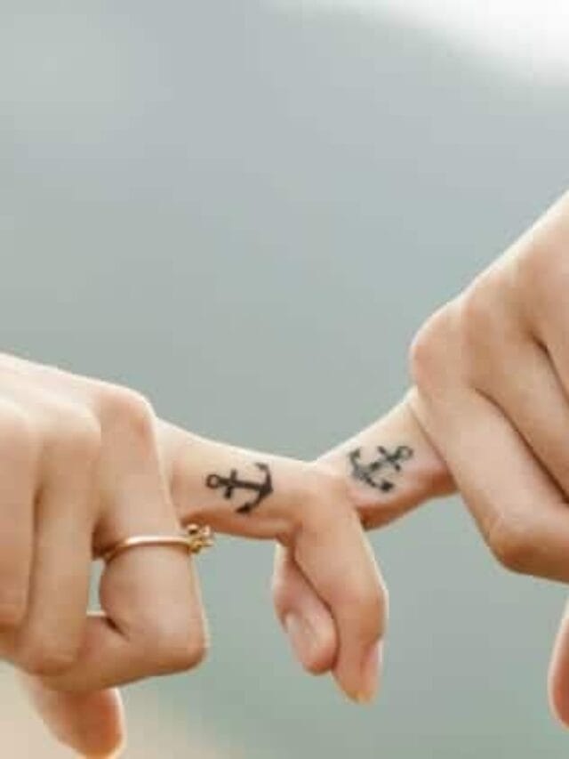 Couple with tattoo holding hands