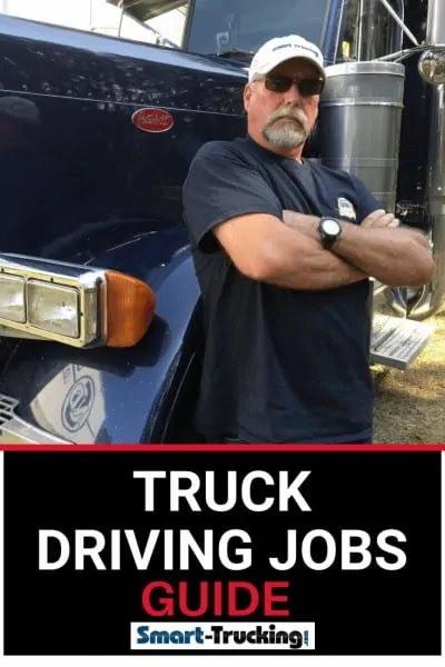 Truck driver standing beside truck