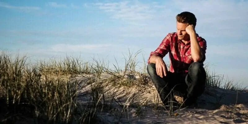 Adult mental health man thinking at beach