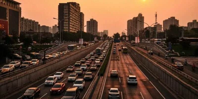 Cars on busy city freeway at sunset