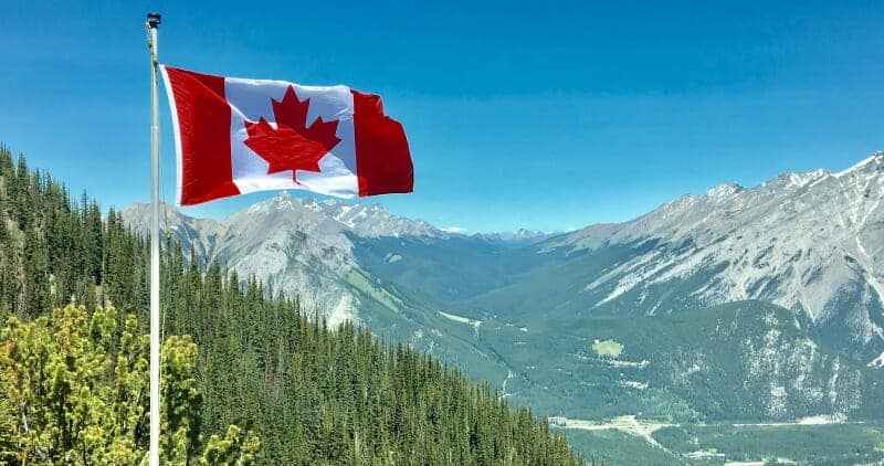 Canada Flag and the Mountains in Background Canada Flag