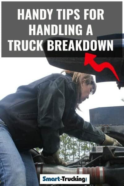 Female checking under the hood of a big rig truck