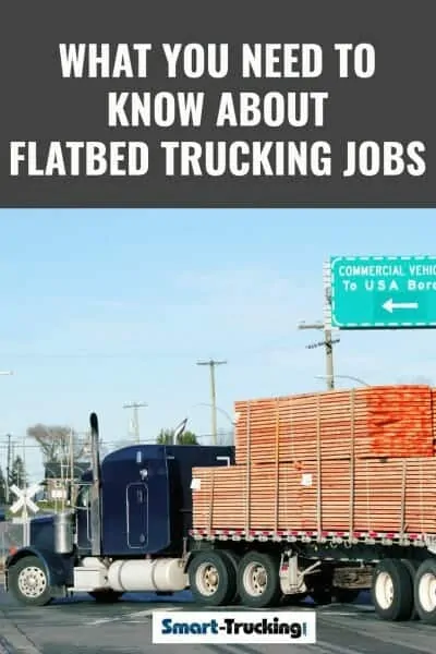 Peterbilt truck pulling a load of lumber on a flatbed trailer