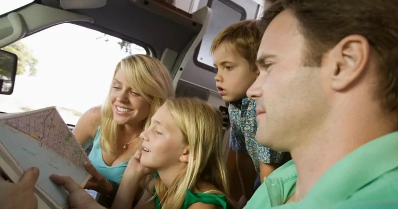 Family looking at road map on vacation