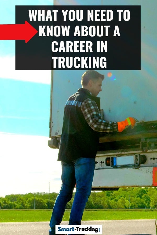 Truck driver opening doors of trailer by roadside. 