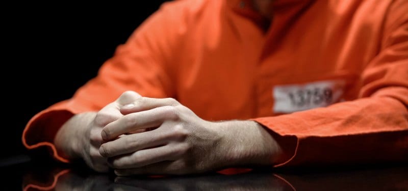 Man in jail in orange suit