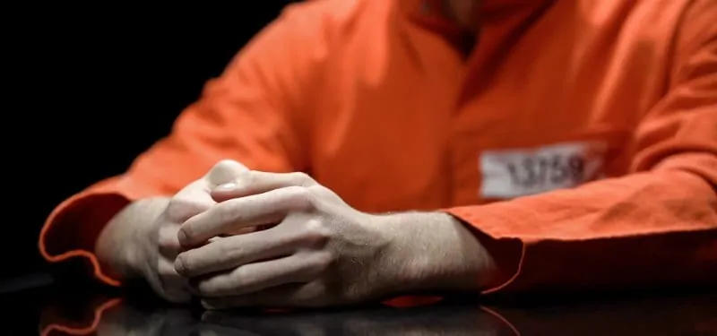 Man in jail in orange suit