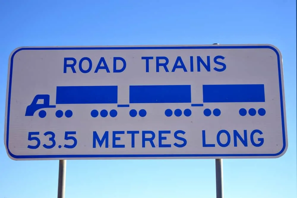 Road Trains Sign in against blue sky in central Australia outback.