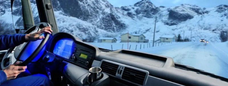 Truck Driver Maneuvering Semi Truck on Snow Covered Road