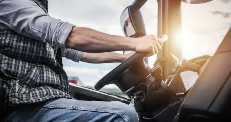 Truck Driver Behind the Wheel. Semi Truck Driving and Transportation Industry.