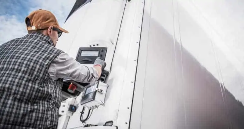 Driver operating reefer motor on temperature controlled trailer