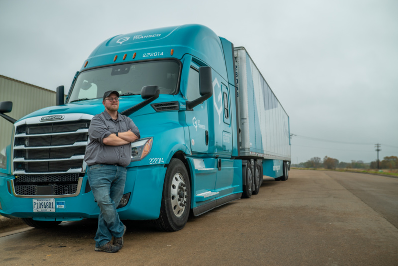 A photo of a GP Transco Truck and truck driver.