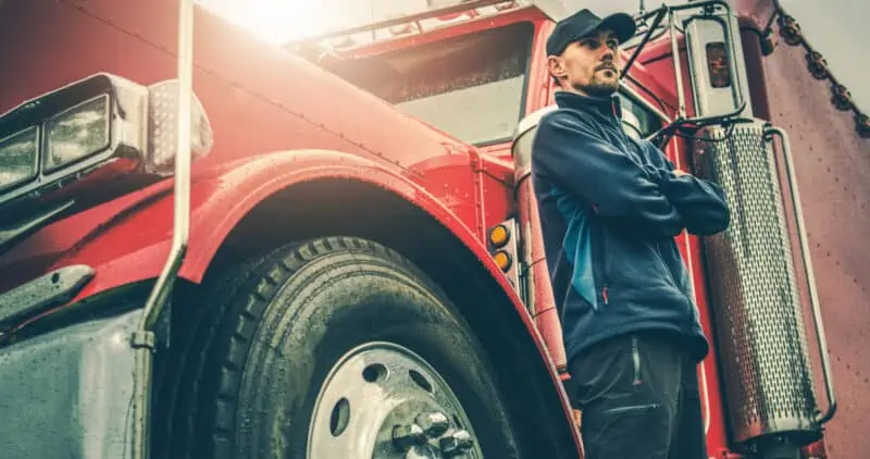 truck driver standing beside his rig