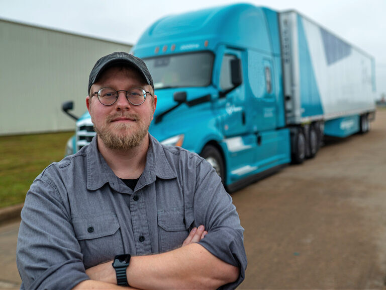 Truck Driver Standing Beside his Truck and Trailer