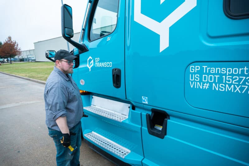 Truck Driver inspecting his truck