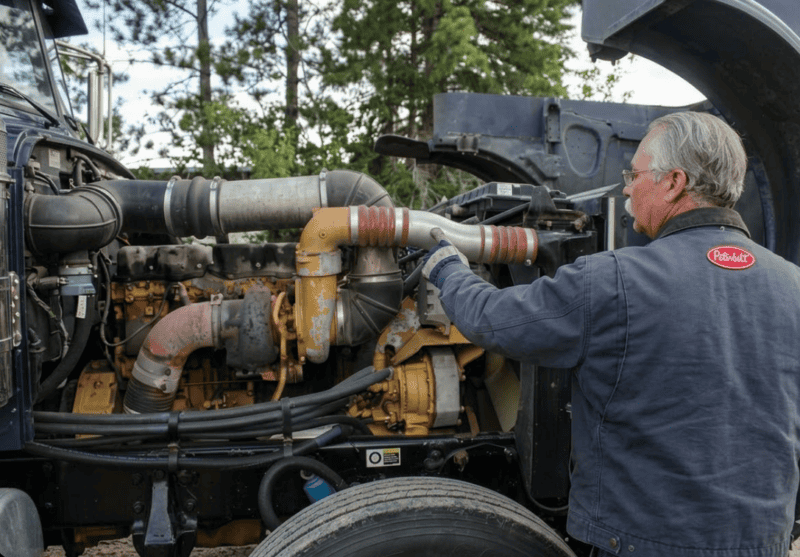 Truck Driver Working on his Cat engine