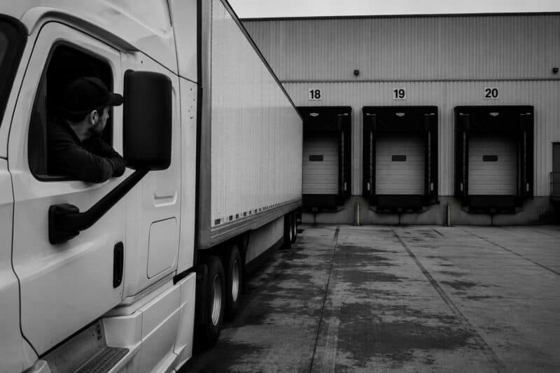 Truck driver looking at loading dock from his truck
