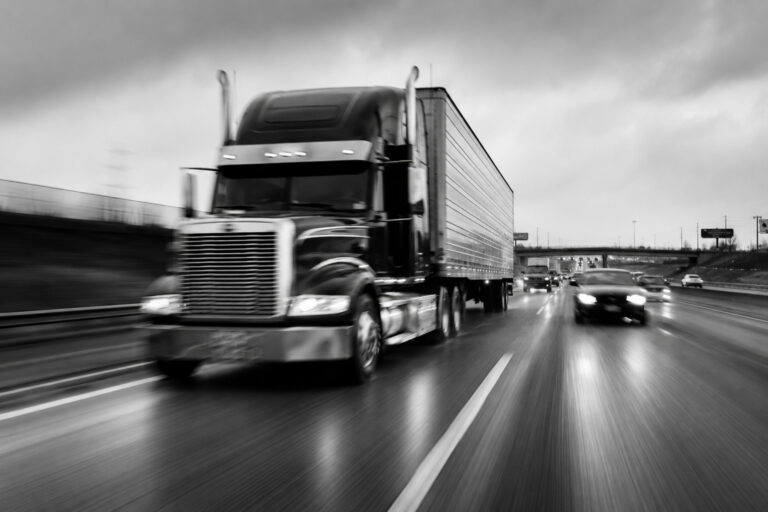 Semi truck and trailer speeding on wet highway